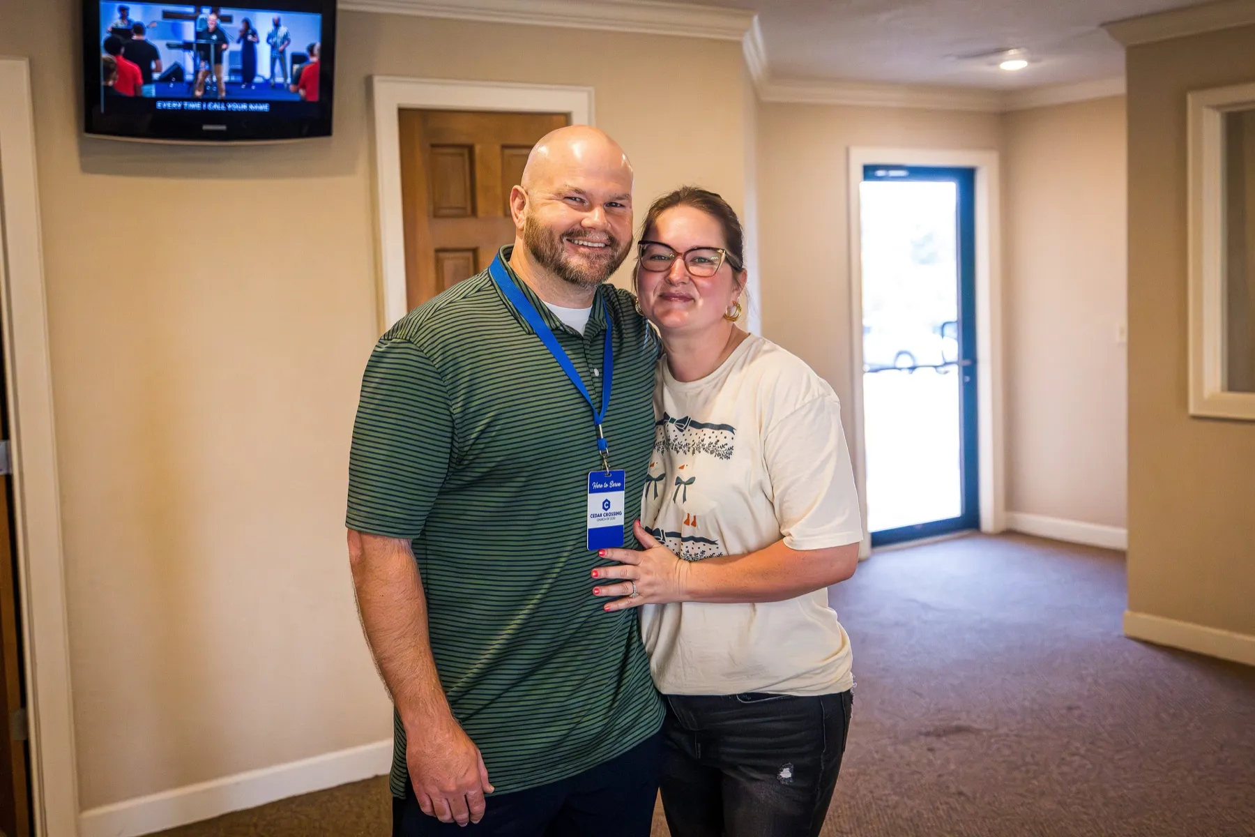 A smiling couple in the Cedar Crossing welcome area