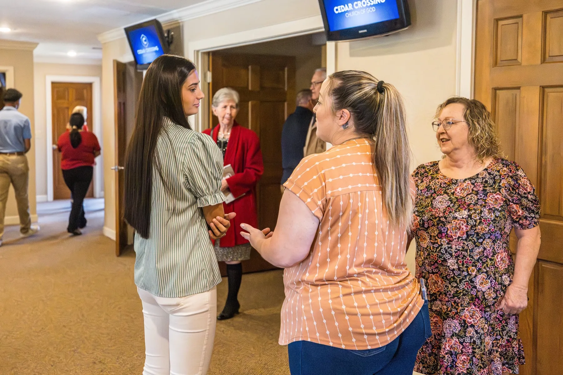 Women connecting in the Cedar Crossing welcome area